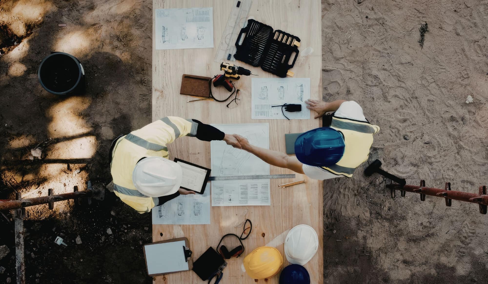 Construction workers reviewing drawings on site